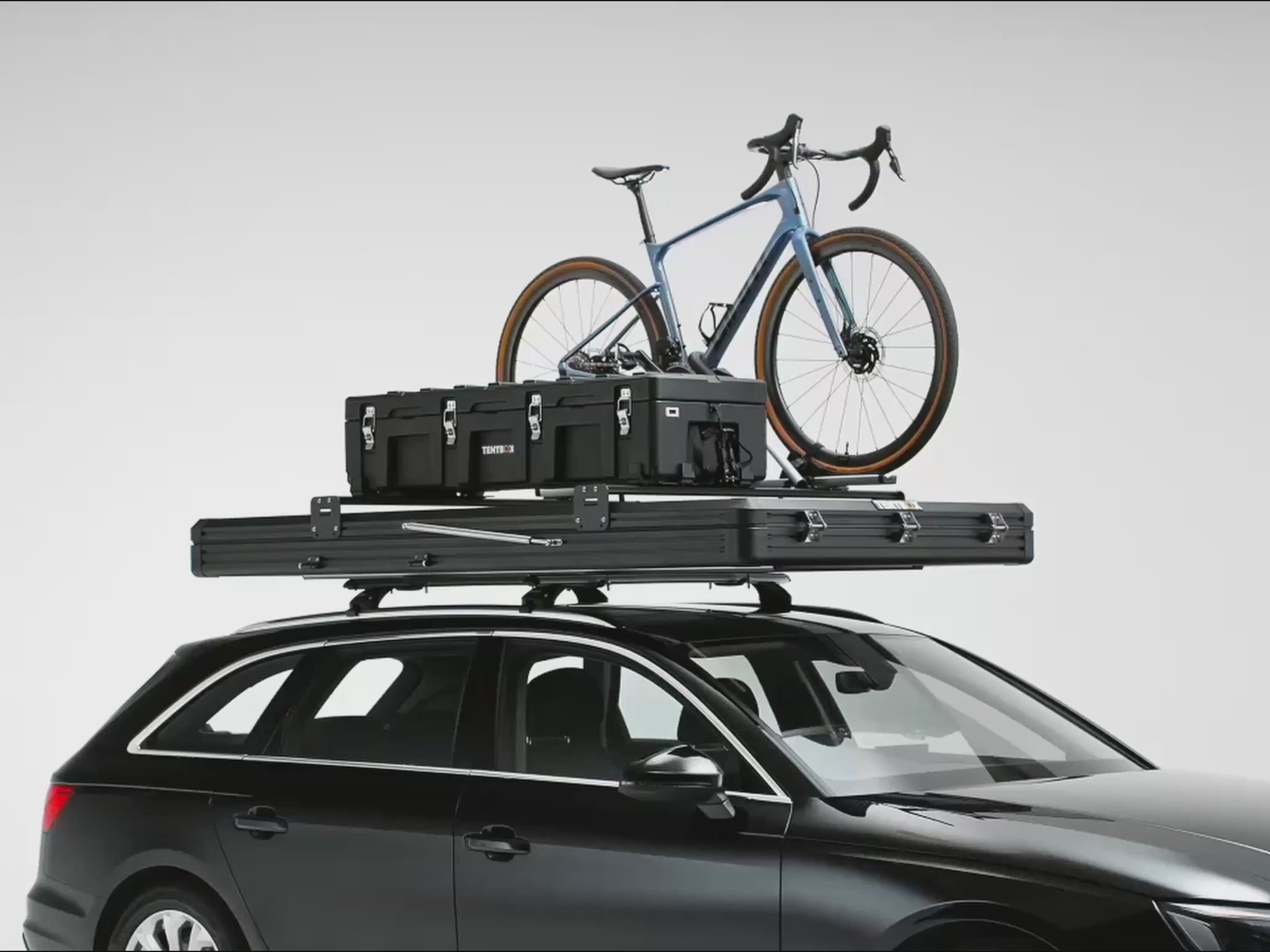 A 360 video of the  TentBox Cargo 2.0  roof tent loaded with cargo bars open and closed on top of a car [autoplay]